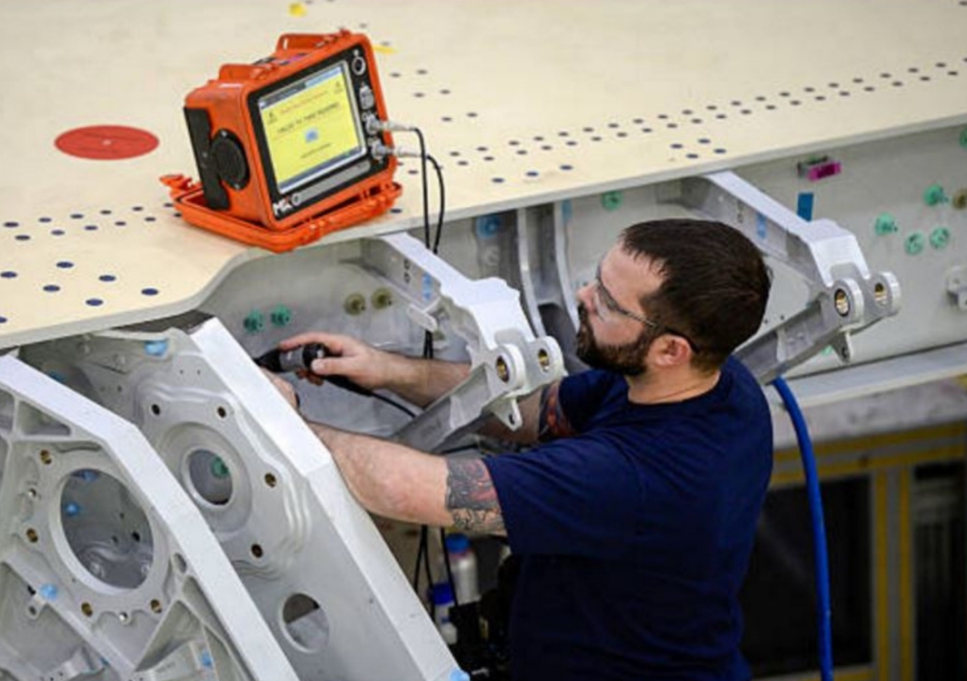 Aircraft technician testing the bond resistance between structural elements