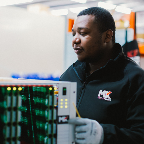 Engineer carrying out preventative maintenance on MK Test Systems test equipment